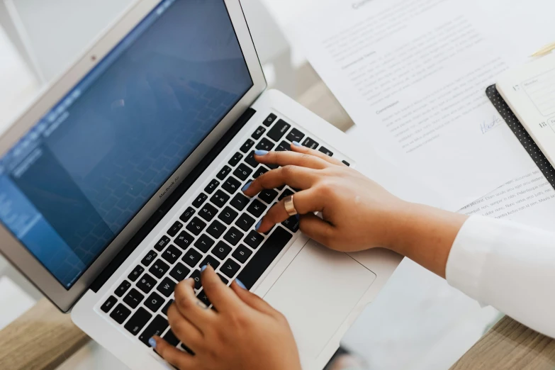 a close up of a person typing on a laptop, pexels, screenshot, multiple stories, paper, corinne day