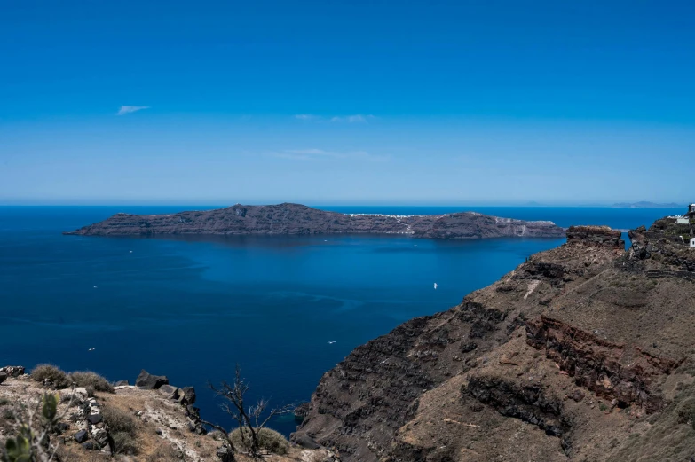 a mountain cliff is next to a body of water