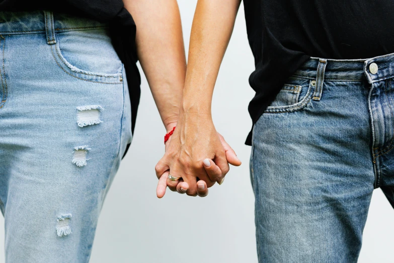 two people who are holding hands next to each other