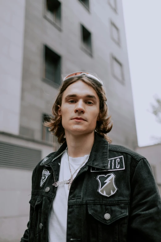 a young man wearing a jacket and a t shirt