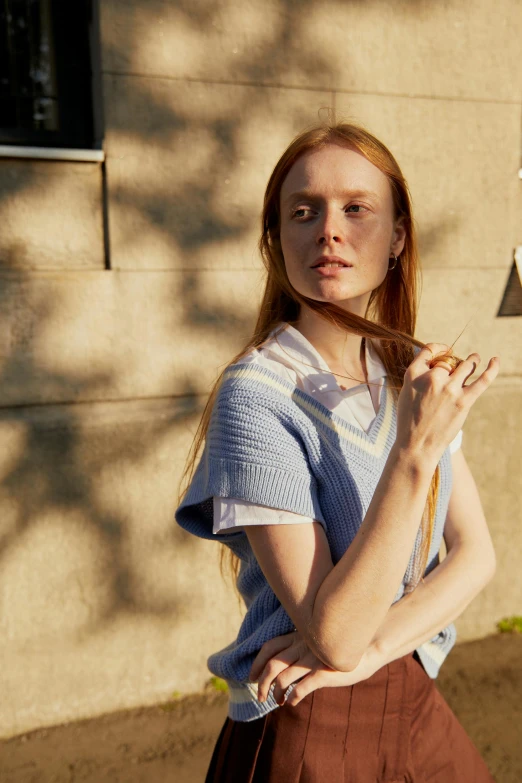 a beautiful young woman holding a tennis racquet, unsplash, renaissance, pale blue outfit, official prada editorial, wearing stripe shirt, ellie bamber