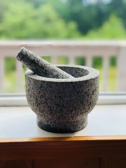 a mortar and a pestle on a window sill, inspired by Gatōken Shunshi, unsplash, in gunmetal grey, granite, ”ultra realistic, heavy grain