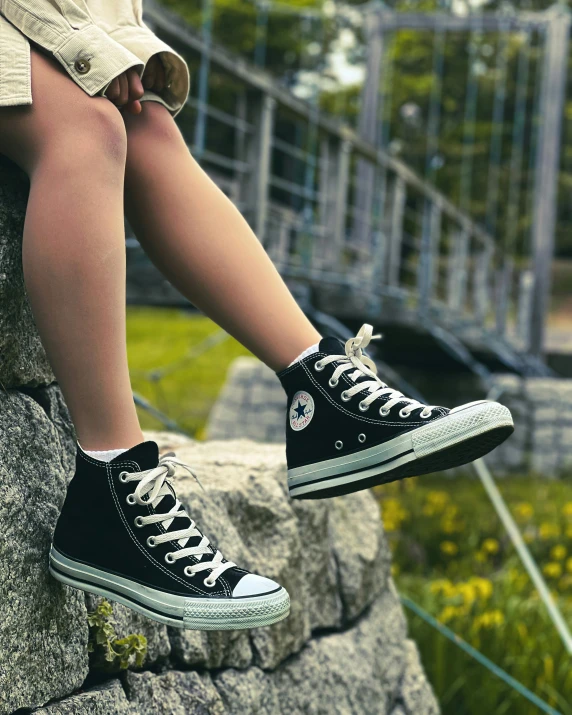 a close up of a person sitting on a rock, converse, 155 cm tall, product introduction photo, full shot ( fs )