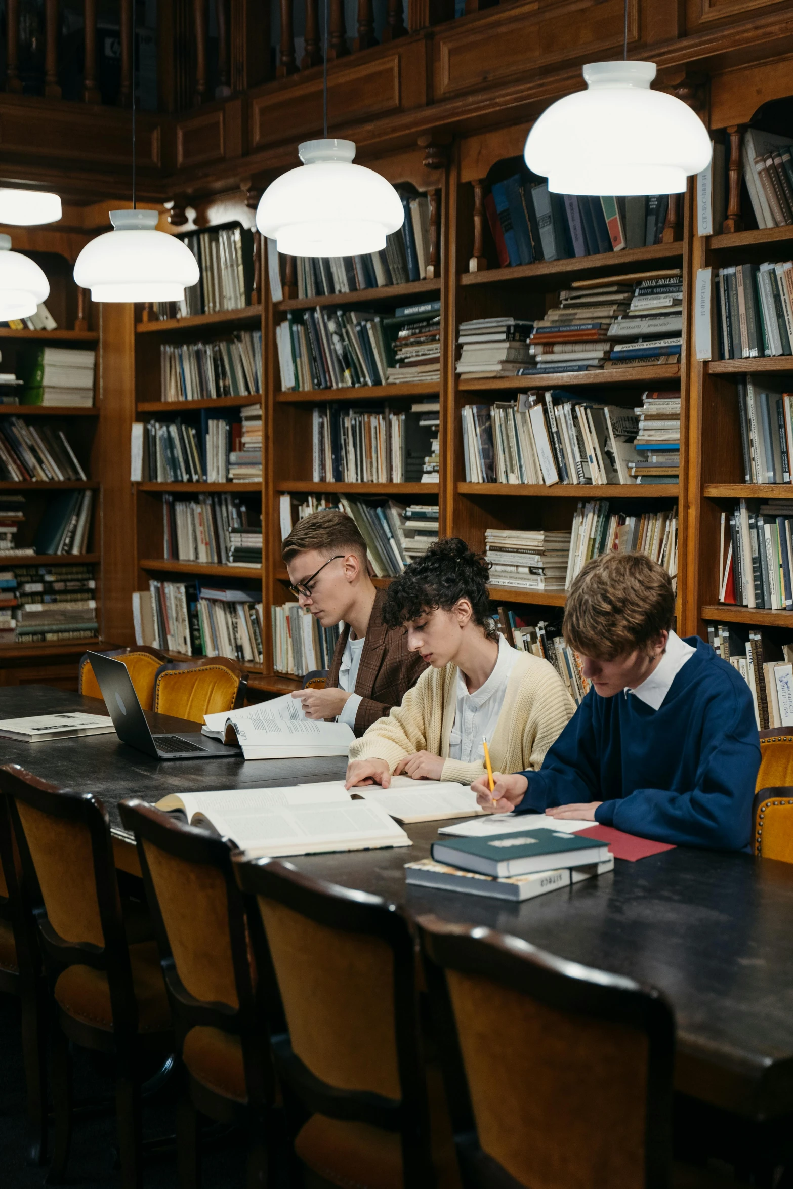a group of people sitting at a table in a library, by Adriaen Hanneman, unsplash, academic art, cute boys, low quality photo, digital image