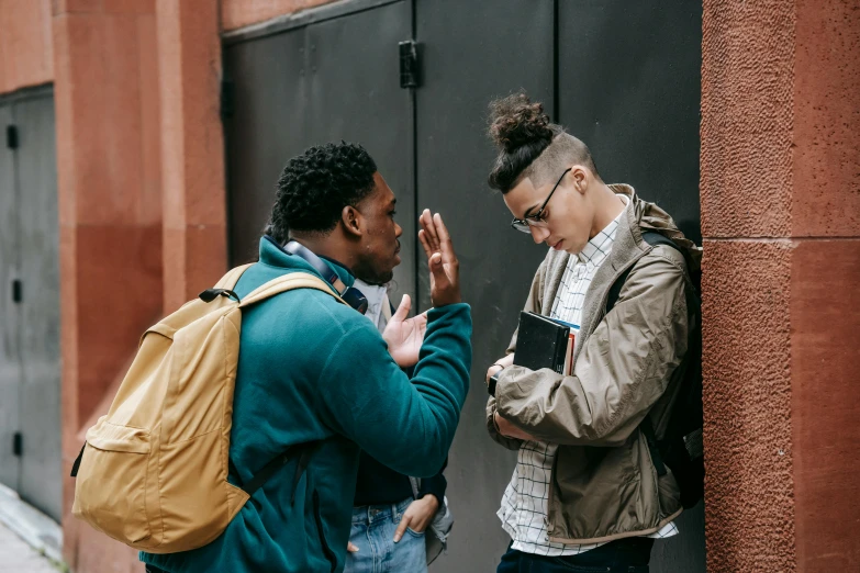 a couple of men standing next to each other, trending on pexels, schools, greeting hand on head, arguing, black teenage boy