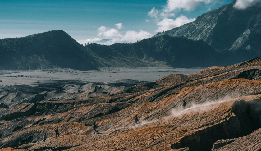 two people riding a dirt bike on a mountain