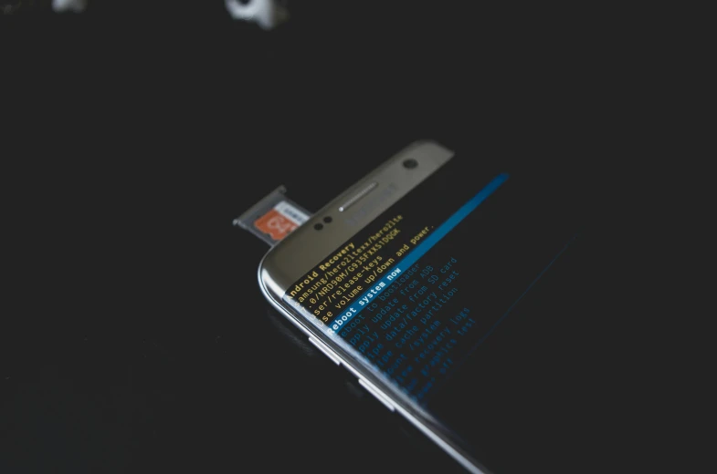 a close up of a cell phone on a table, a hologram, by Android Jones, pexels, hacking into the mainframe, adafruit, ilustration, hidden message