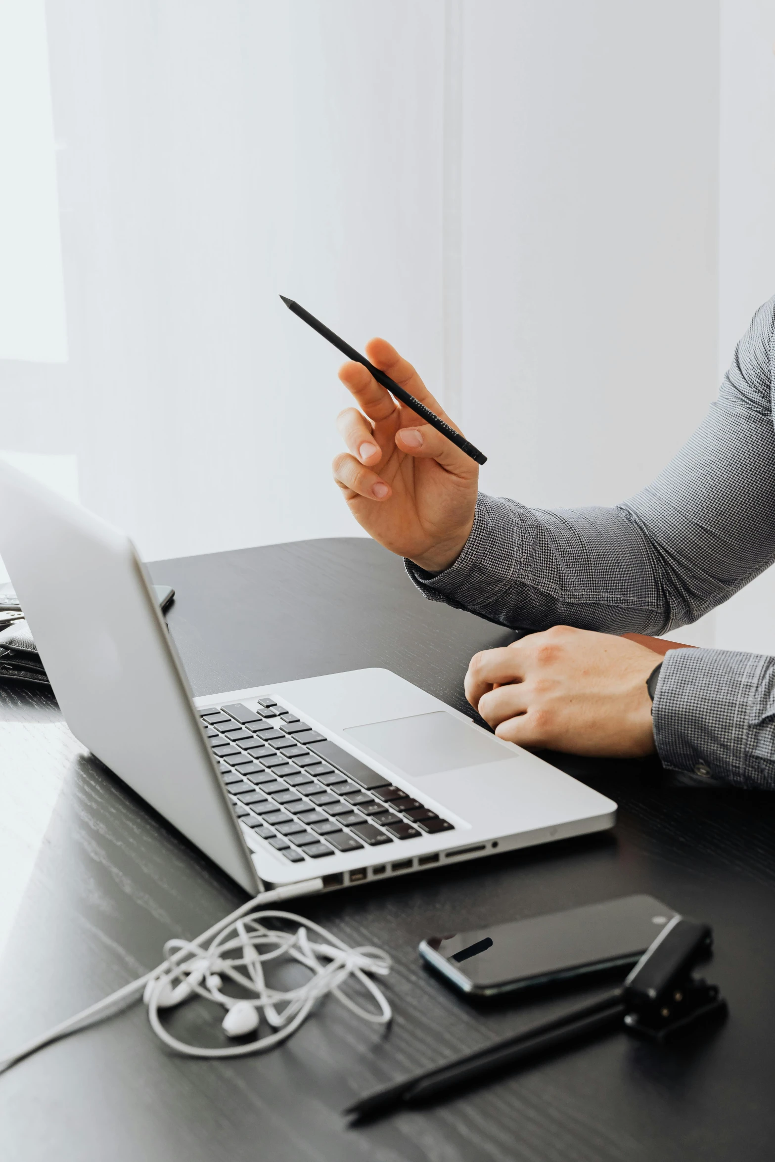 a man sitting at a desk using a laptop computer, a computer rendering, trending on pexels, holding a trident, hold up smartphone, professional detailed photo, wire management