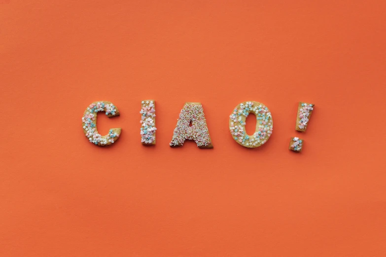 the word chaos spelled with sprinkles on an orange background, by Olivia Peguero, international typographic style, gucci bread, cai guo-qiang, teaser, dio