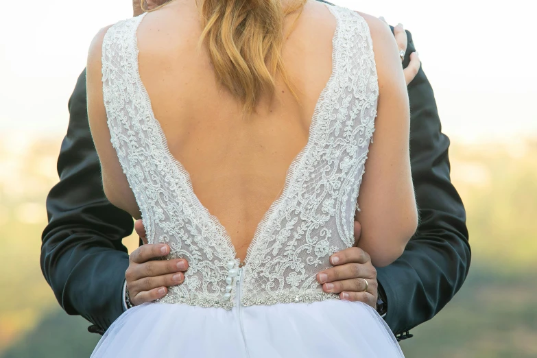 a man and a woman standing next to each other, by Gwen Barnard, pexels, the dress\'s lower, his back is turned, middle close up shot, celebrating an illegal marriage