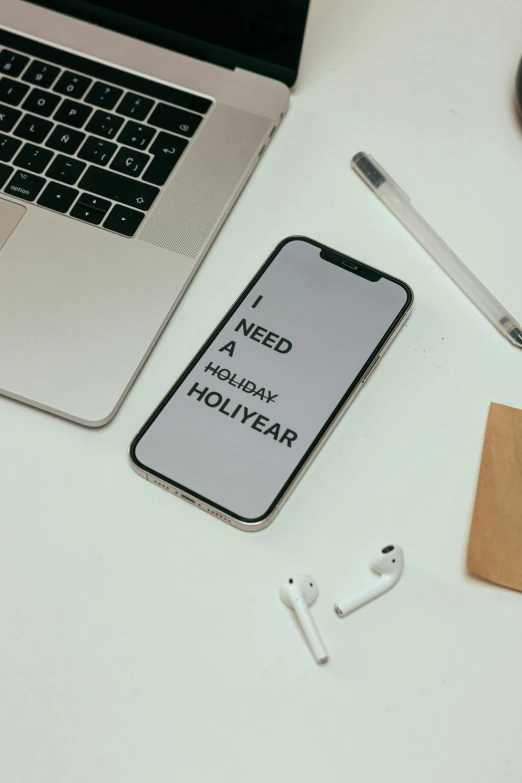 a laptop computer sitting on top of a white desk, by Robbie Trevino, trending on pexels, holography, corporate phone app icon, words, holiday, halfrear