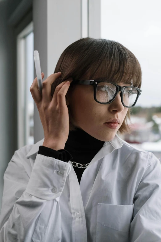 a woman in a lab coat talking on a cell phone, inspired by mads berg, trending on pexels, wearing square glasses, futuristic hairstyle, pokimane, black on white