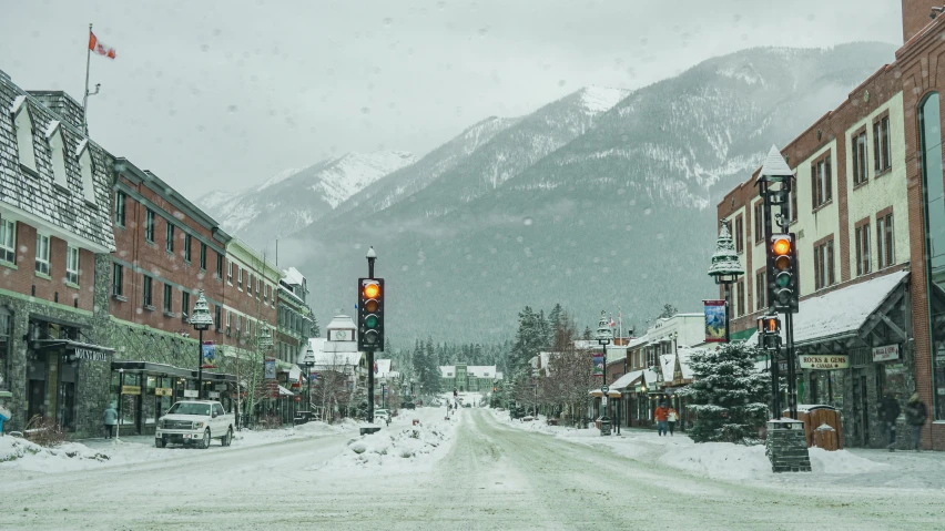 a snow covered street surrounded by tall buildings