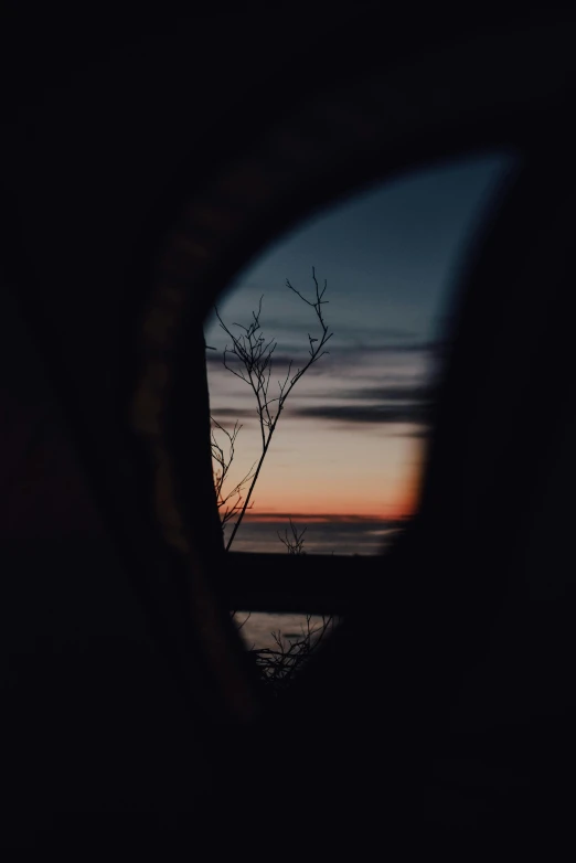 a reflection of a tree in the side mirror of a car, by Jacob Toorenvliet, unsplash contest winner, romanticism, looking out over the sea, ((sunset)), looking into a mysterious cave, high quality photo