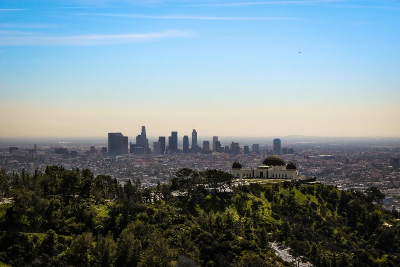 a view of a city from the top of a hill, by Meredith Dillman, unsplash contest winner, los angelos, sunny day time, parks and monuments, towering high up over your view