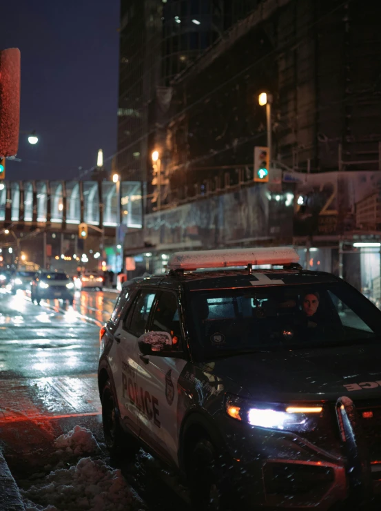 a police car on a city street at night, inspired by Elsa Bleda, unsplash, photorealism, cinematic 8k uhd, nypd, ultra realistic 8k octan photo, cinematic lut