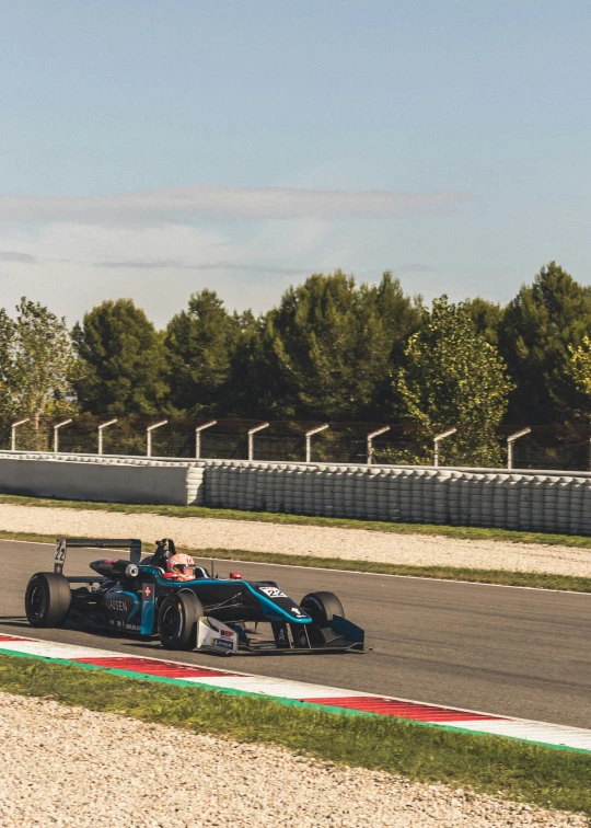 a race car driving on a track with trees in the background, by Carlo Martini, unsplash, renaissance, square, blue and black scheme, in spain, banner