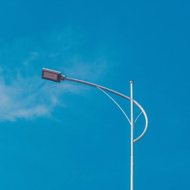 the stop sign is suspended above a traffic light