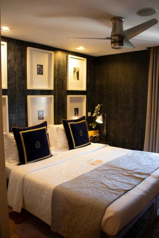 a room with a white bed and pictures on the wall