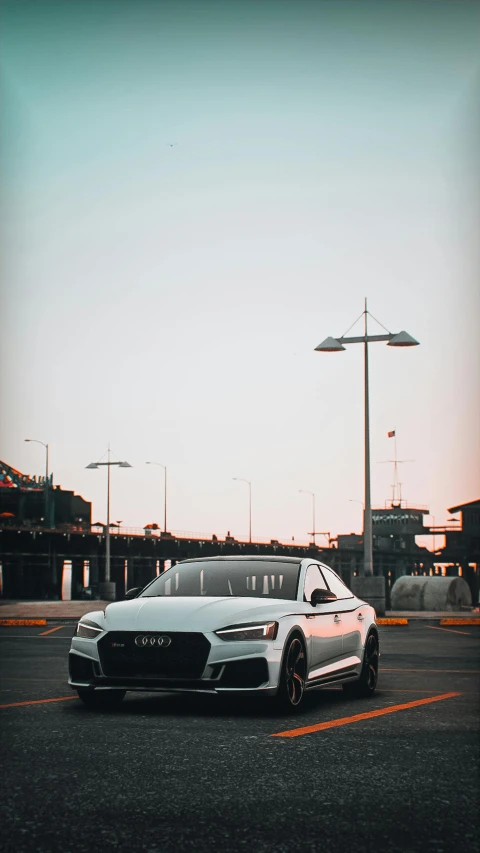 a silver sedan parked in front of a tall building