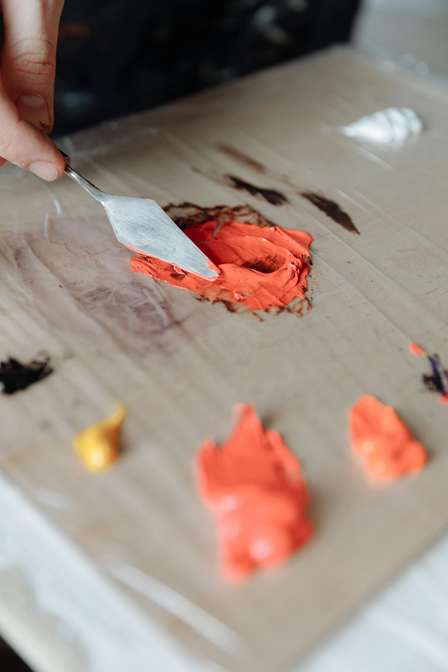 a person cutting a piece of cake with a knife, a photorealistic painting, inspired by Lynda Benglis, trending on pexels, color palette is dark orange, fingerprints on clay, carefully crafted, creating a soft