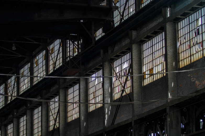 a train that is sitting inside of a building, a portrait, by William Woodward, unsplash contest winner, brutalism, steel mill, detail structure, charles sheeler, the windows are lit