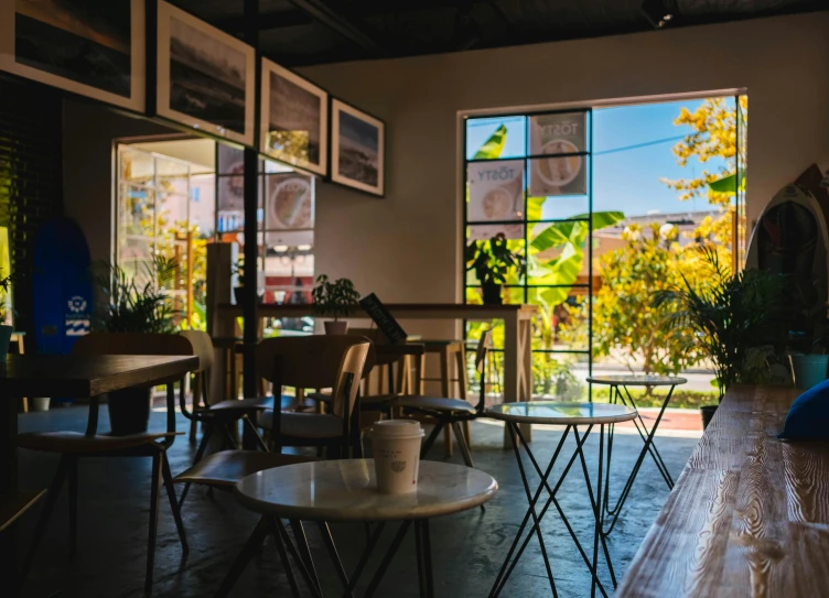 an open cafe with tables and chairs set for eight