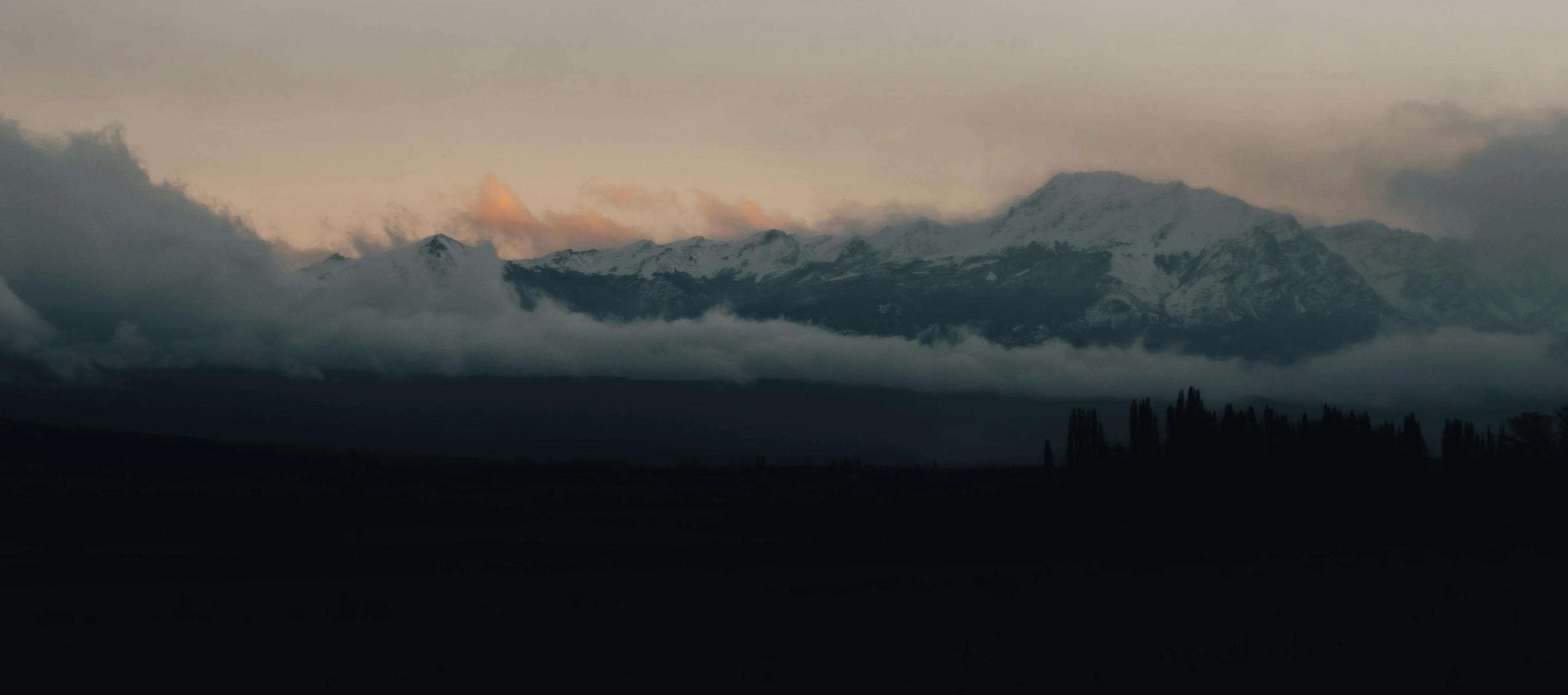 a view of a mountain covered in clouds, inspired by Elsa Bleda, pexels contest winner, tonalism, snow capped mountains, crepuscule, grey, andes