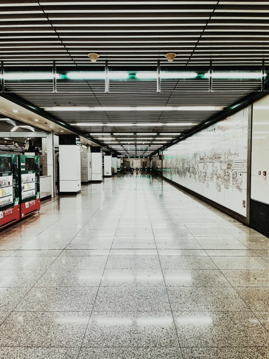 a red and white bus parked inside of a train station, inspired by Thomas Struth, unsplash contest winner, hyperrealism, spaceship hallway, streets of hong kong, 🚿🗝📝, shiny marble floor