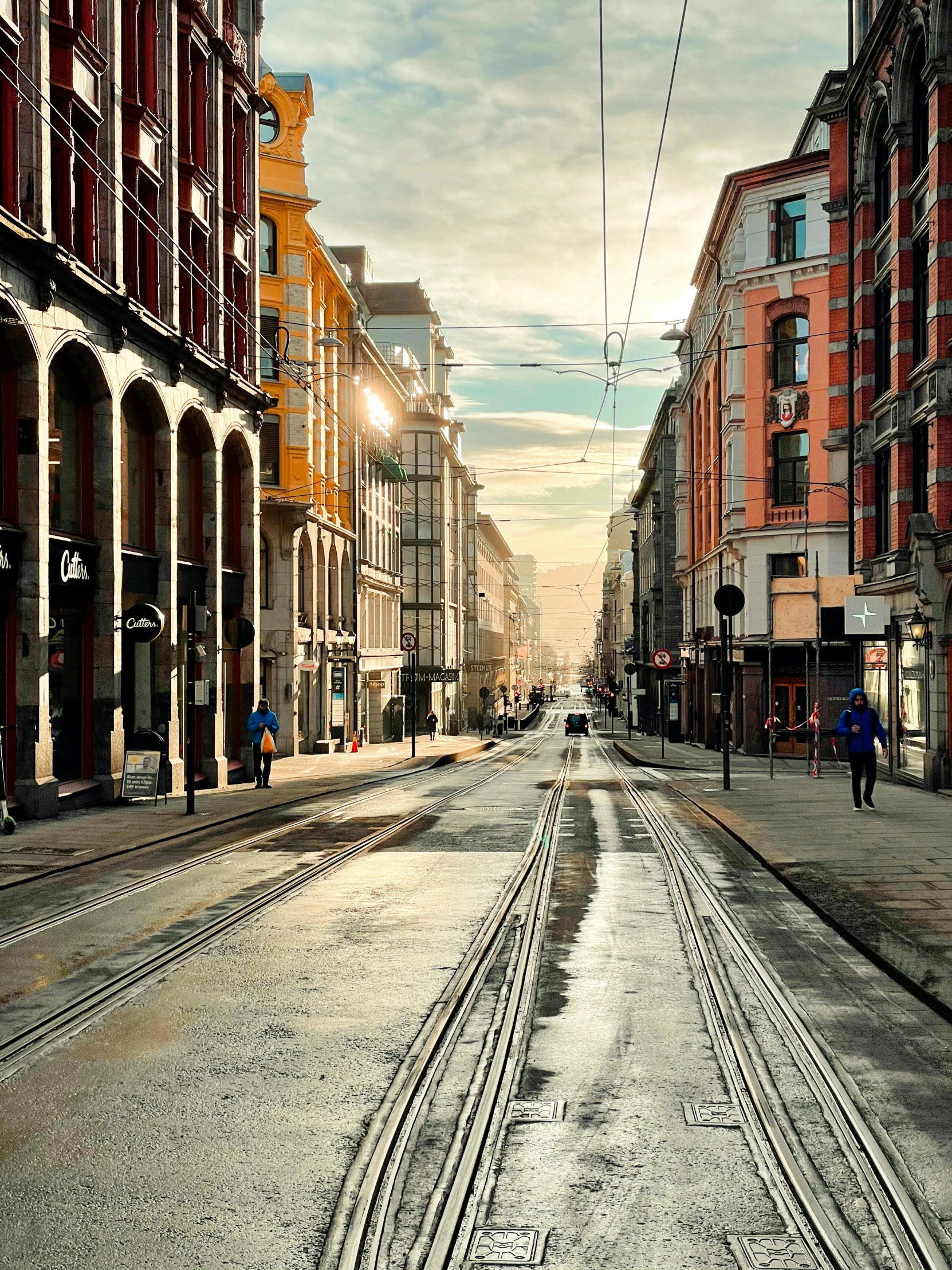 a city street filled with lots of tall buildings, an album cover, pexels contest winner, hyperrealism, helsinki, victorian city, italian mediterranean city, cinematic morning light