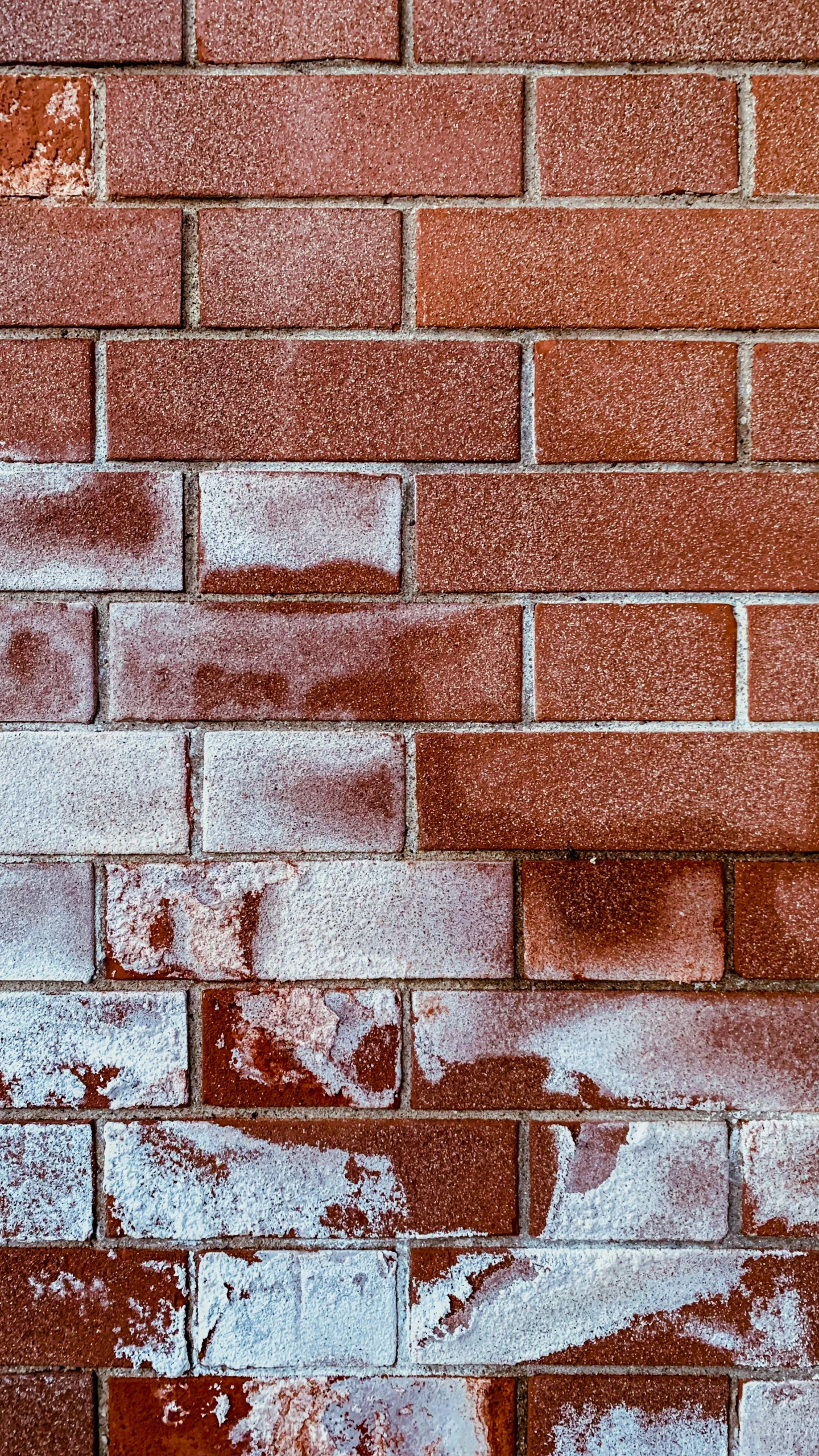 a brick wall with some graffiti on it