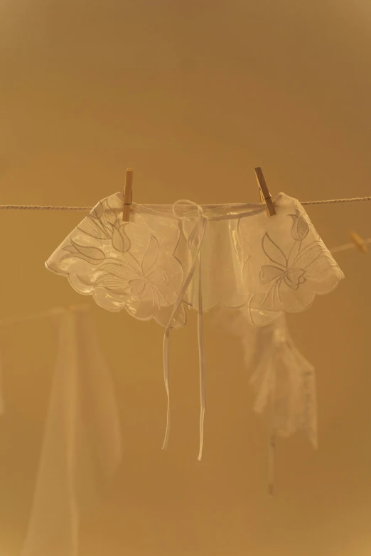 a set of two white umbrellas hanging from strings