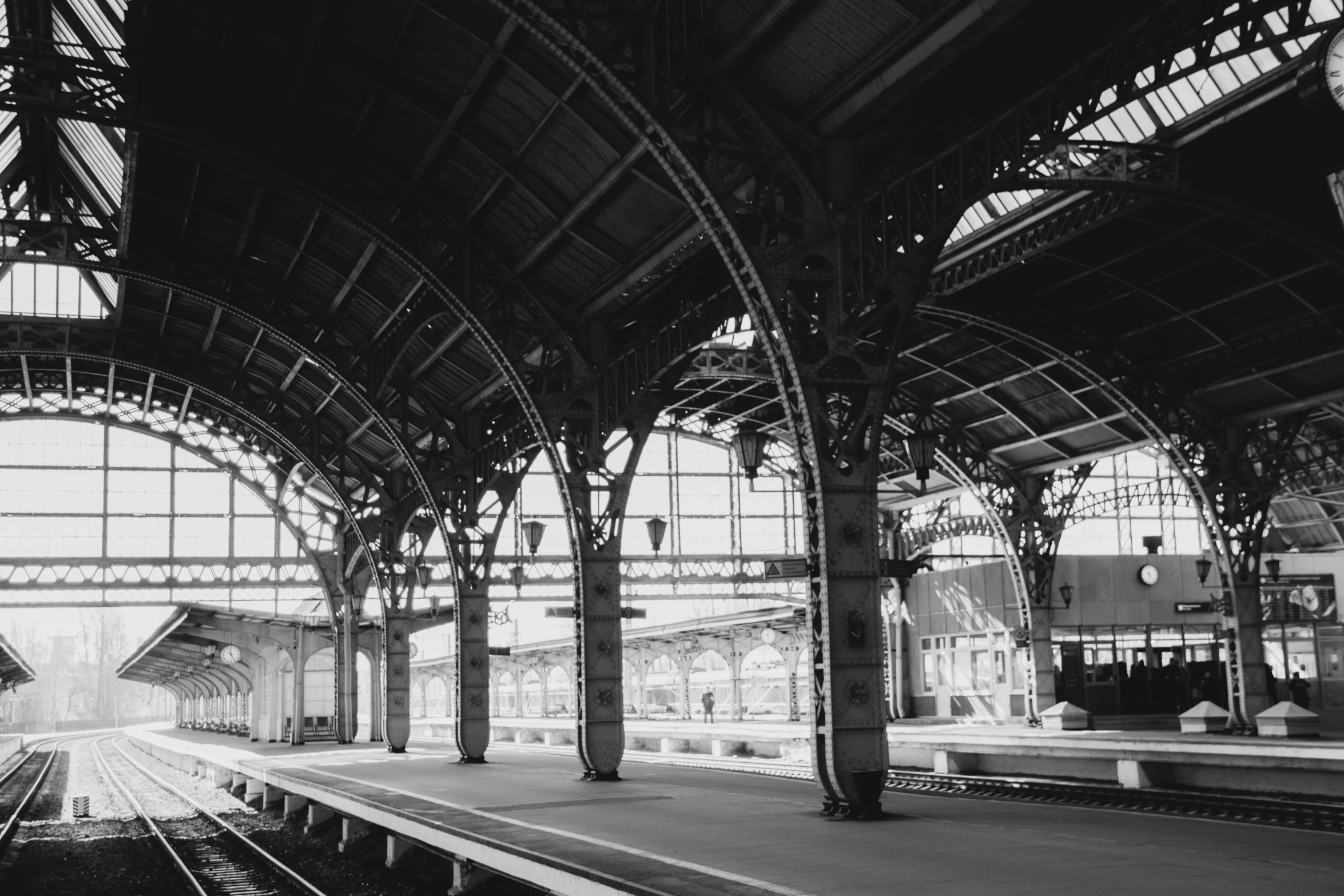 a black and white photo of a train station, inspired by Thomas Struth, unsplash contest winner, art nouveau, square, brown, full daylight, gothic aesthetic