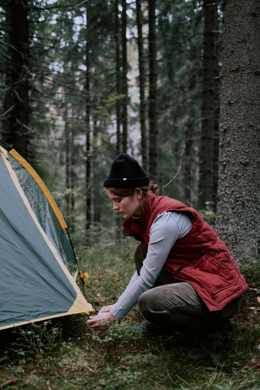 a woman setting up a tent in the woods, a picture, by Anna Haifisch, profile image, portra, show, rectangle