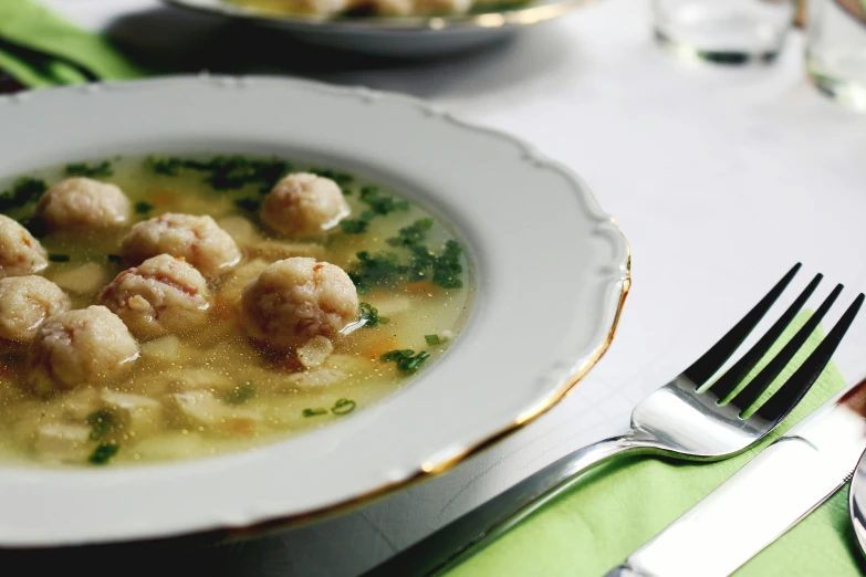 a close up of a plate of food on a table, good soup, ball, no cropping, recipe