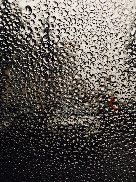 a close up of water droplets on a glass, an album cover, by Adam Rex, unsplash contest winner, hyperrealism, glass and metal : : peugot onyx, shot on iphone, it\'s raining, patterns and textures