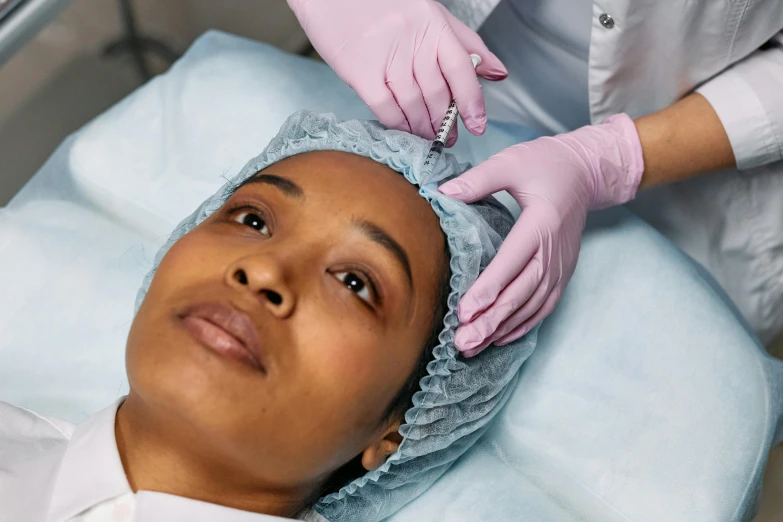 a woman getting her hair done in a salon, trending on pexels, renaissance, holding a syringe, detailed facial structure, african ameera al taweel, in hospital bed