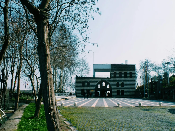 a large building sitting in the middle of a park, inspired by Serafino De Tivoli, pexels contest winner, berlin secession, venice biennale, 1990's photo, private academy entrance, nekro petros afshar