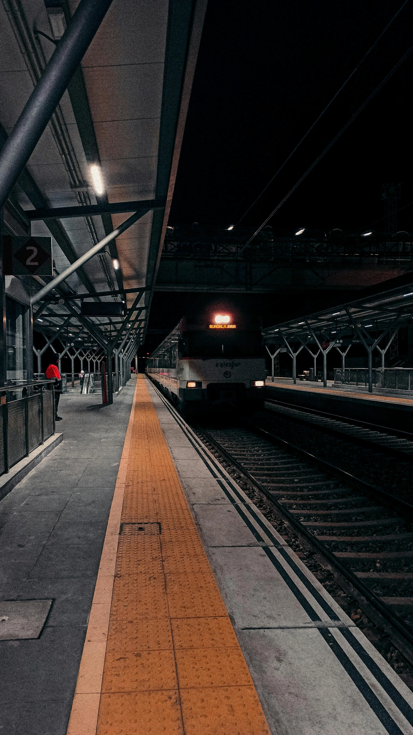 a train pulling into a train station next to a platform, a picture, unsplash contest winner, dark. no text, square, tokio, waiting