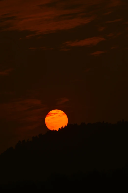 the sun is setting on top of a hill, by Jim Nelson, july, uttarakhand, digital yellow red sun, devils