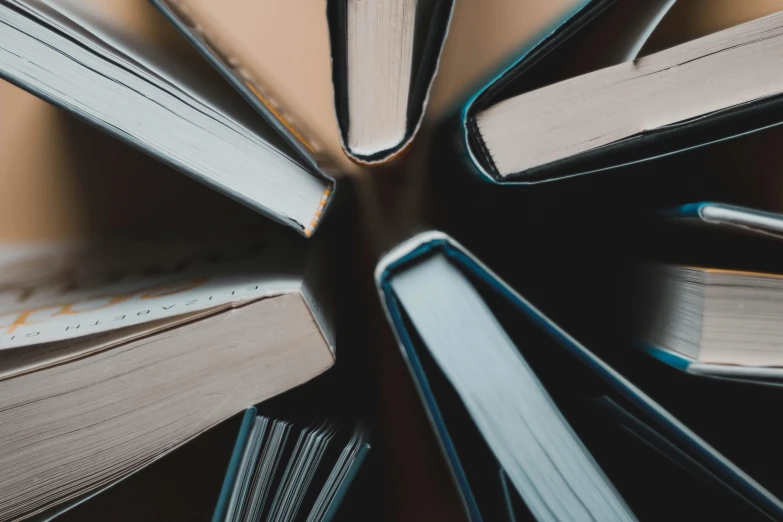 a pile of books sitting on top of a table, pexels contest winner, analytical art, high angle close up shot, sleek spines, avatar image, thumbnail