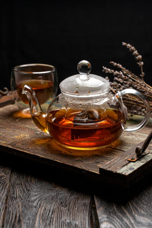 a tea pot sitting on top of a wooden tray, a still life, shutterstock, square, honey, mid night, botanicals