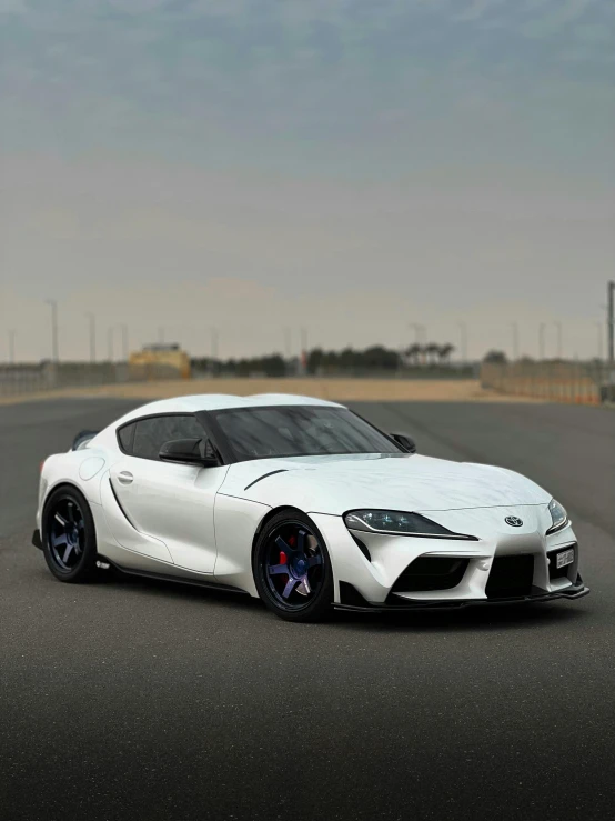 the white sports car has black rims and chrome wheels