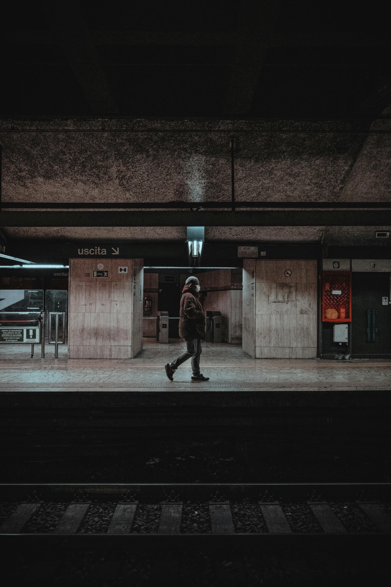 a man walking through a train station at night, inspired by Elsa Bleda, unsplash contest winner, realism, dystopian brutalist atmosphere, a lonely woman, masked person in corner, instagram photo