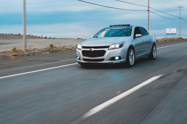 a silver car is driving down the road, a portrait, unsplash, avatar image, drifting, gm, cory behance hd