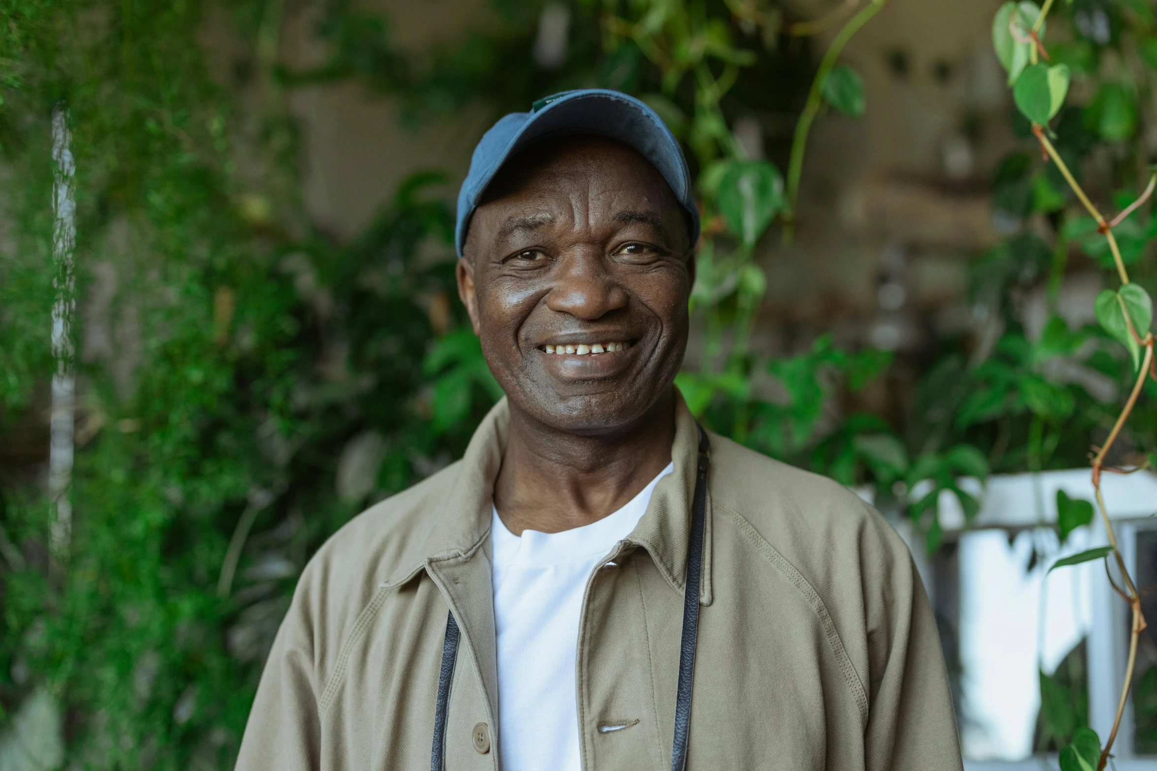 a black man is standing and smiling for the camera