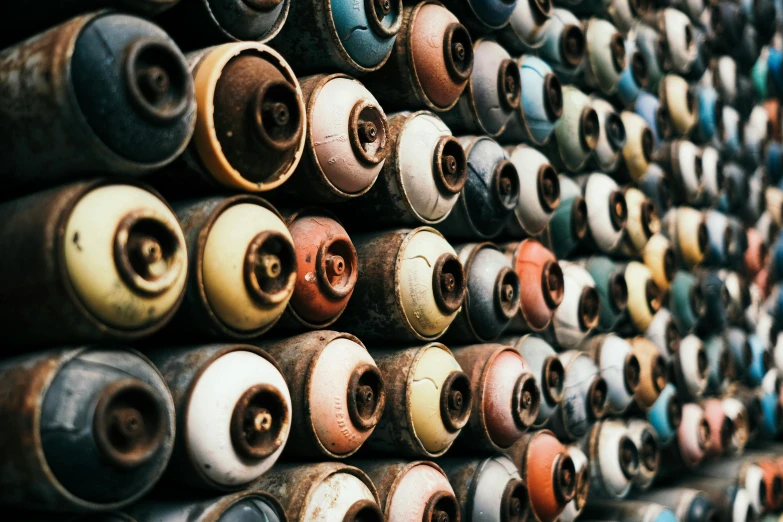 a bunch of spray cans stacked on top of each other, an airbrush painting, unsplash, rusty pipes, instagram post, beads, sustainable materials