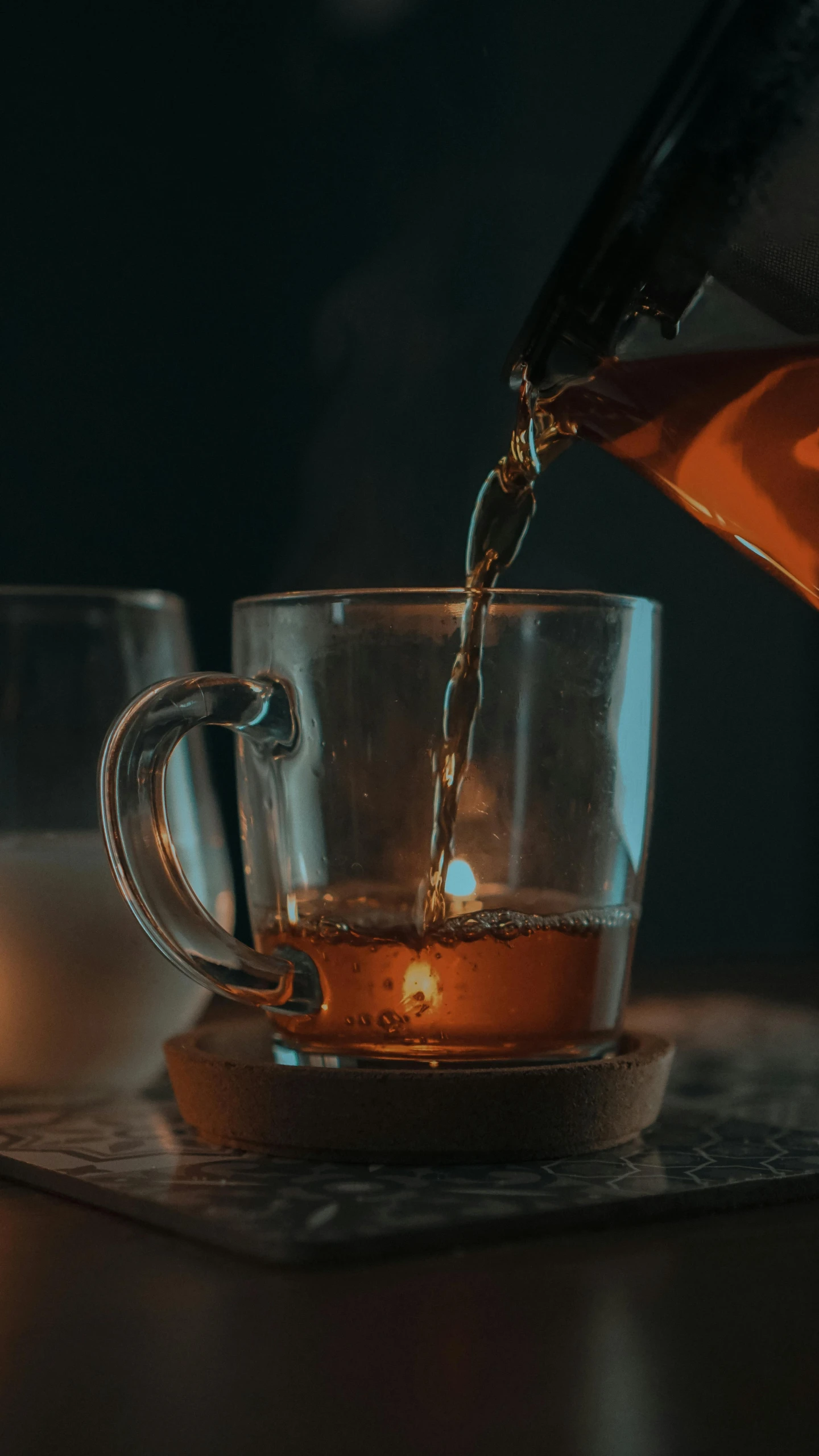 a person pouring tea into a glass cup, a screenshot, by Adam Marczyński, pexels contest winner, renaissance, soft glow, square, brown, nightcap