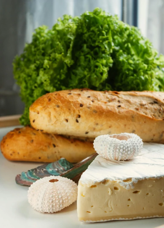 some bread, greens and a knife on a plate