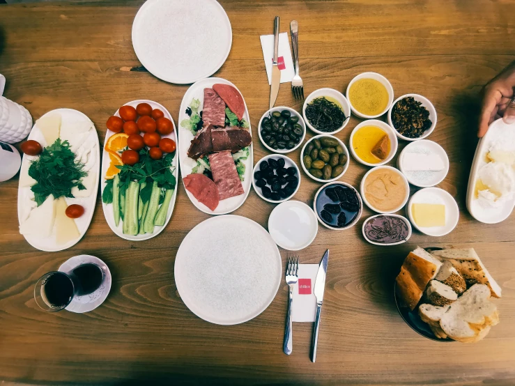 a wooden table topped with plates of food, pexels contest winner, dau-al-set, turkish and russian, full body image, ingredients on the table, grey